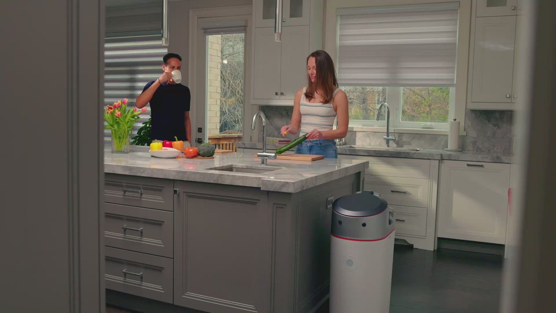 Husband and Wife putting Food Scraps to Get Real Compost with the LILA Home Electric Indoor Composter