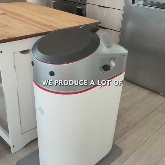 Woman turning food scraps into Category A compost with the LILA Home Electric Indoor Composter